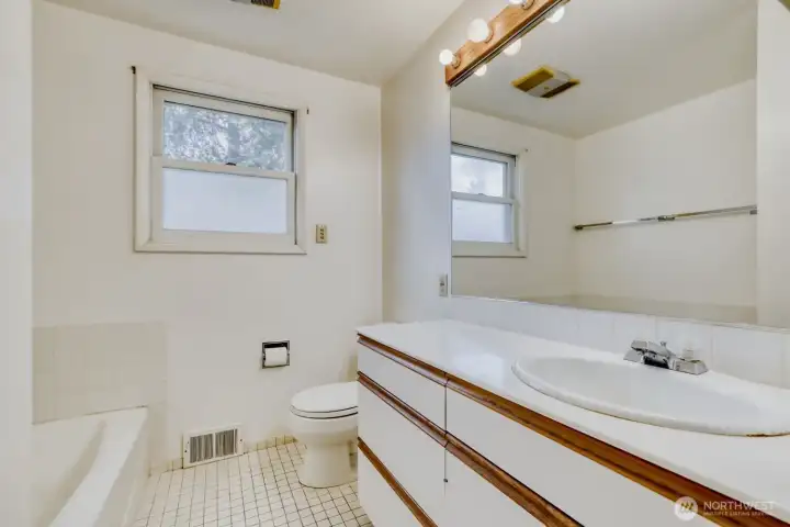 Main Floor Full Bath. Separate shower enclosure to the left of the tub (not seen in this photo).