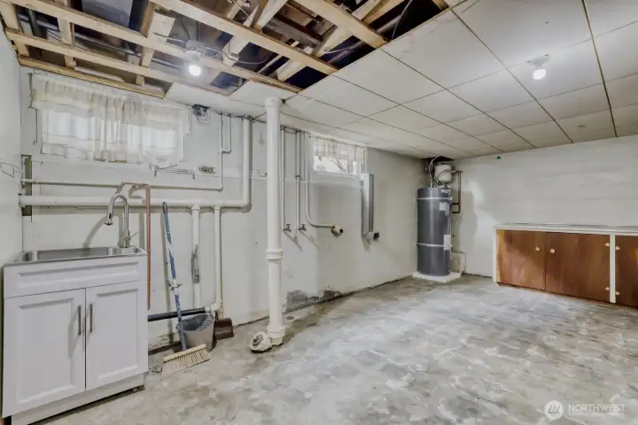 Huge Laundry Room in Basement. Brand new Water Heater and Utility Sink. Currently has a concrete floor.