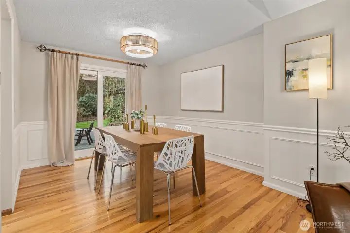 Sliding doors off dining room lead to backyard patio.