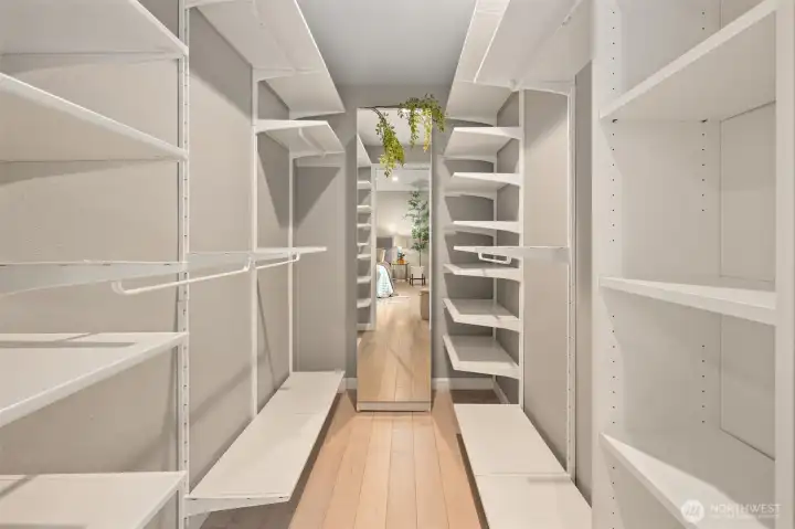 Spacious walk-in closet with custom built-ins.