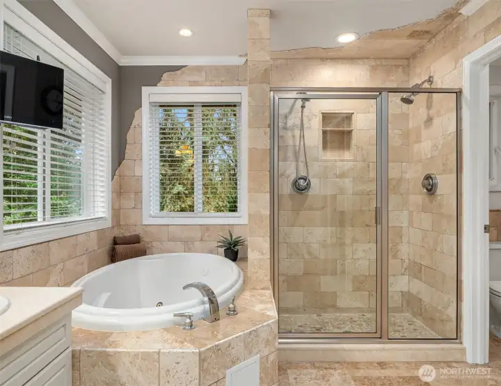 The primary en'suite 5 pc bath w/custom tile, heated floors and jetted tub. Adjacent is a custom walk-in closet. The primary en'suite 5 pc bath w/custom tile, heated floors and jetted tub. Adjacent is a custom walk-in closet.