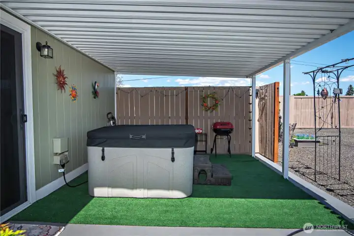 Covered Back Patio and new hot tub outside of Primary Bedroom