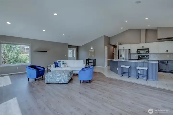 Open living and dining area with vaulted ceilings and expansive windows framing Columbia River views. Open living and dining area with vaulted ceilings and expansive windows framing Columbia River views.