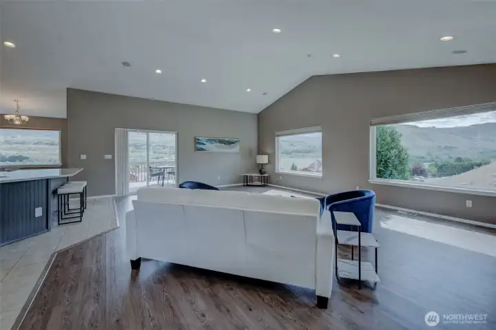 Stunning great room featuring soaring vaulted ceilings, picture windows, and breathtaking river views. Stunning great room featuring soaring vaulted ceilings, picture windows, and breathtaking river views.