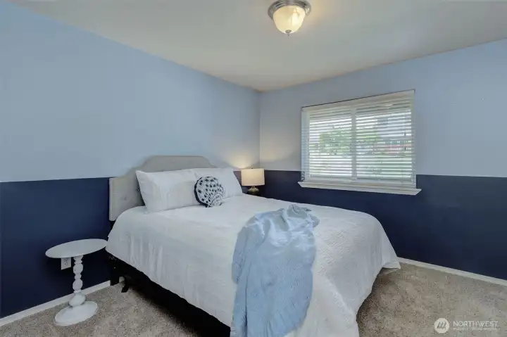 Main-level secondary bedroom offering comfortable space and natural light. Main-level secondary bedroom offering comfortable space and natural light.