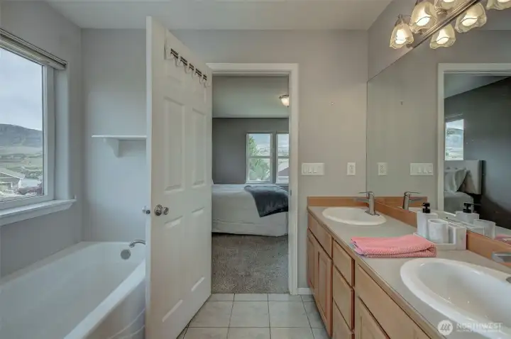 Luxurious 5-piece primary bathroom featuring soaking tub and spa-like atmosphere. Luxurious 5-piece primary bathroom featuring soaking tub and spa-like atmosphere.