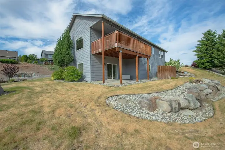 Rear exterior showcasing expansive deck and multiple outdoor living areas. Rear exterior showcasing expansive deck and multiple outdoor living areas.