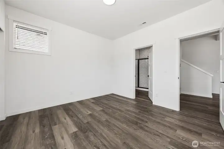 Main-level bedroom with attached 3/4 bathroom.