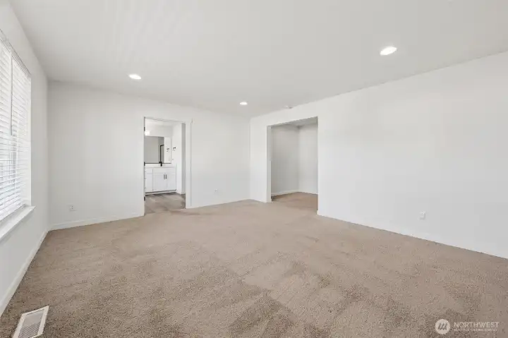 Expansive primary suite with grand entry.