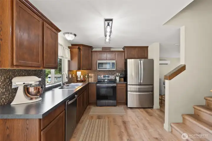 The kitchen offers plenty of counter space, upgraded appliances, and is the comfortable heart of the home. The kitchen offers plenty of counter space, upgraded appliances, and is the comfortable heart of the home.