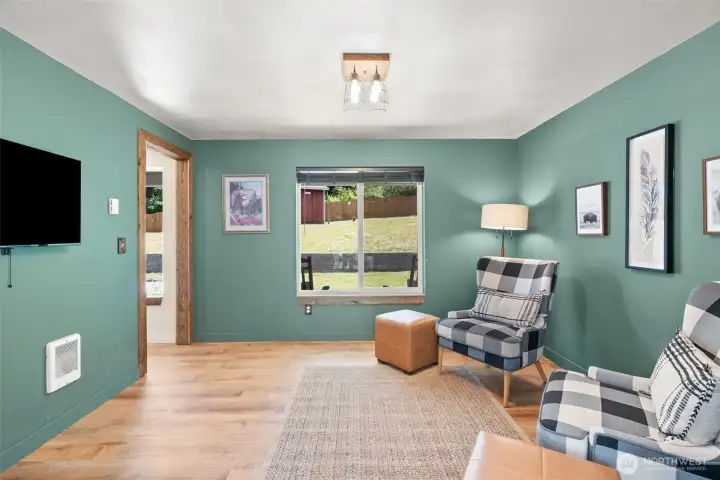 In this family room, perhaps formal dining, play, or office space is just to the left of the front door. In this family room, perhaps formal dining, play, or office space is just to the left of the front door.