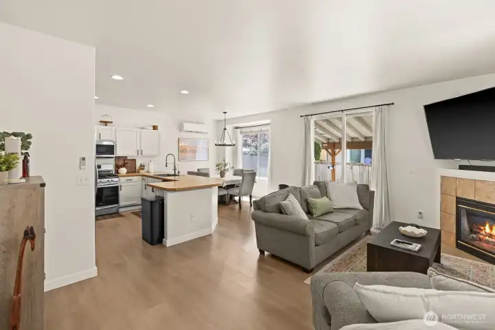 Open concept living, dining and kitchen with sliding doors to the patio and fully fenced yard Open concept living, dining and kitchen with sliding doors to the patio and fully fenced yard