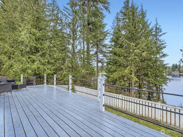 Enormous deck overlooks the lake & your dock below. The perfect spot to start or end your day...an entertaining dream!