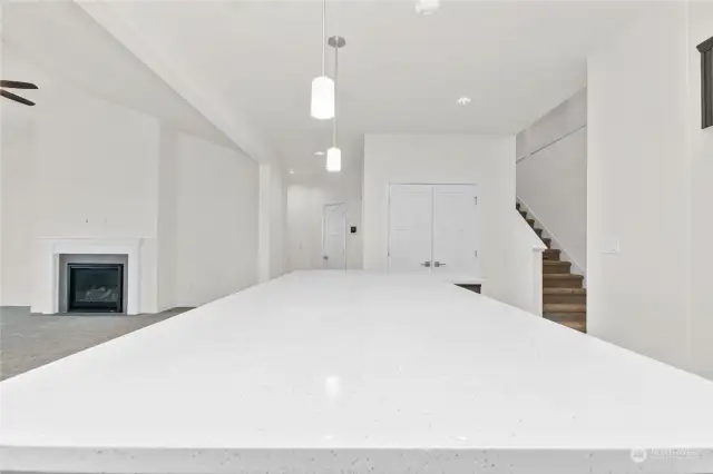 Oversized center island with quartz counter tops in kitchen. Ideal for prepping and entertainment. Photo for illustration only of similar home, not actual.