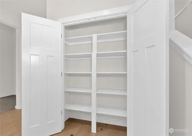 Pantry with solid shelving. Photo for illustration only of similar home, not actual.