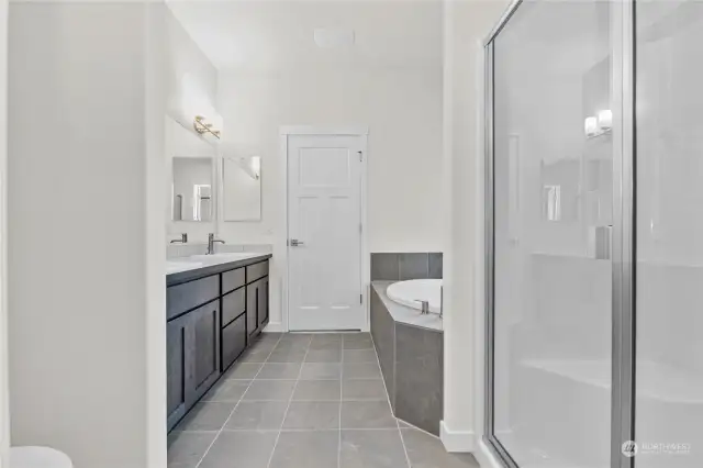 Another view of primary bathroom showing standing shower. Photo for illustration only of similar home, not actual.