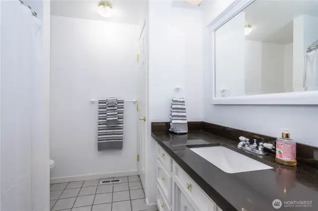 Full main bathroom with built-in linen closet.