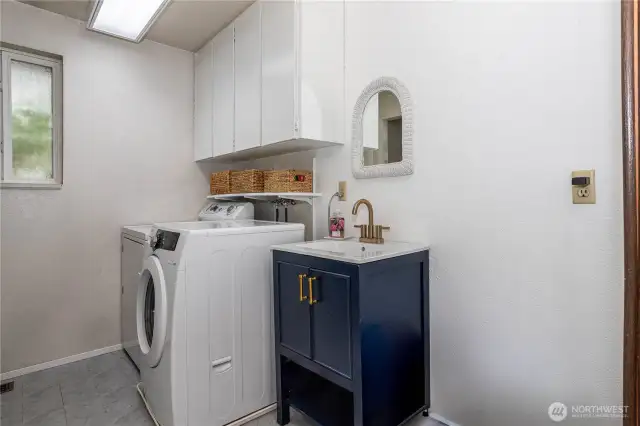 Laundry room has abundant storage & 1/2 bath.