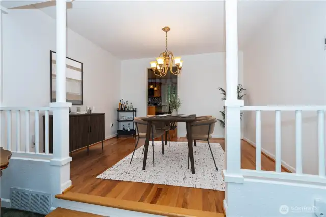 Positioned conveniently between the kitchen & living room, spacious dining room, accented with hardwood floors (digitally staged)