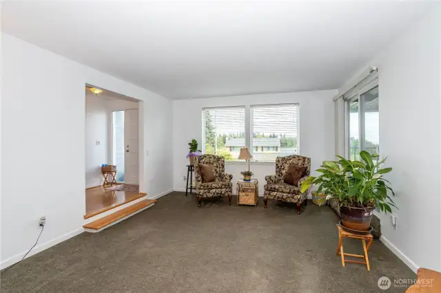 Front door, with side lights, opens to spacious living room; slider to right leads to covered deck, also adjacent to family room.