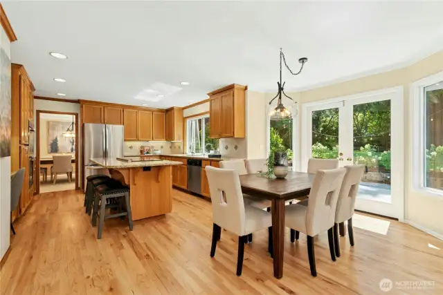 Breakfast nook with double doors opening to the back patio.