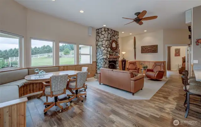Looking toward the primary suite.. The lovely stone fireplace is a calming focal point.