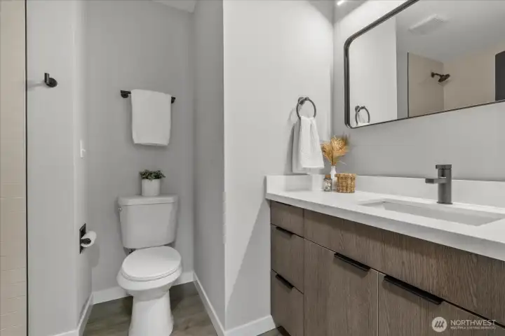 Fully renovated bathrooms with designer tile surrounds and sleek quartz counters