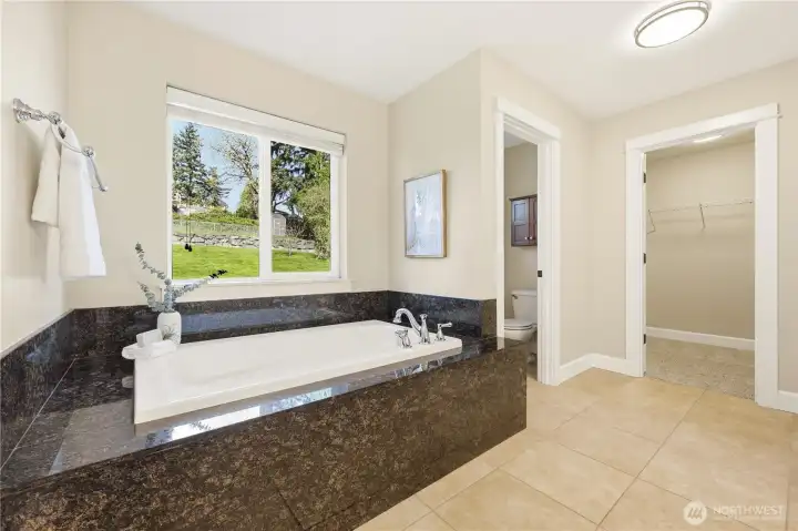 The tub in the primary bathroom is perfect for soaking away stress