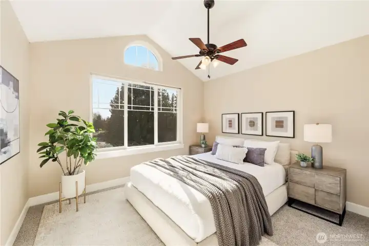 One of the bedrooms at the front of the home featuring vaulted ceilings