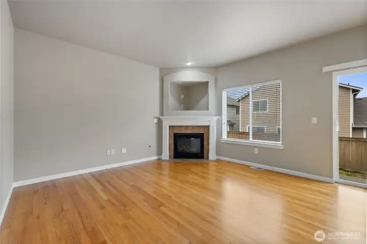 kitchen is open to cozy room with fireplace