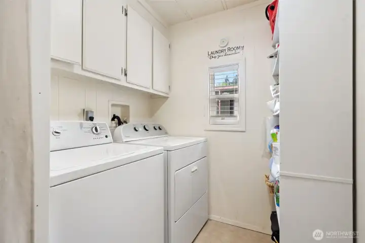 Laundry area with plenty of shelves.