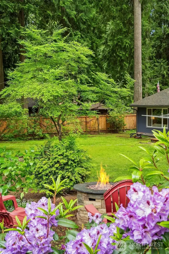 Gorgeous yard with mature landscaping. Tucked away fire pit amidst nature. Gorgeous yard with mature landscaping. Tucked away fire pit amidst nature.
