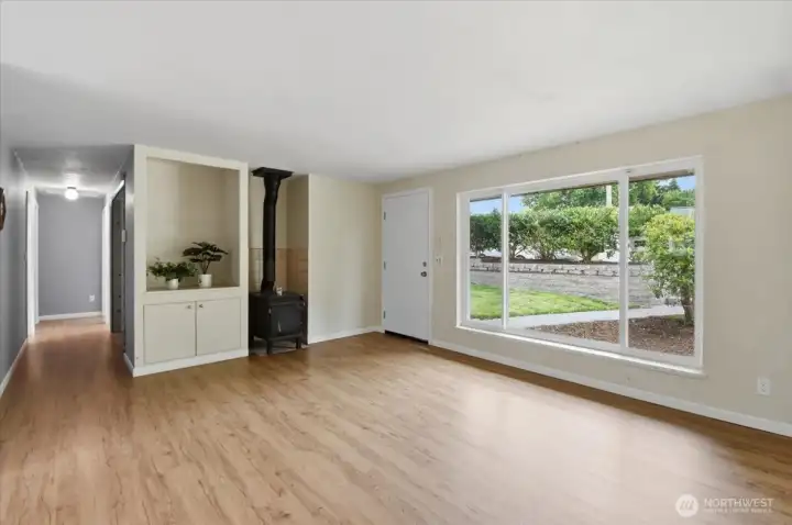 The warmth of a wood-burning stove and recessed display nook are features of the living room along with...