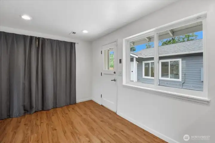 The compact laundry/pantry area is behind the curtain, off the kitchen.