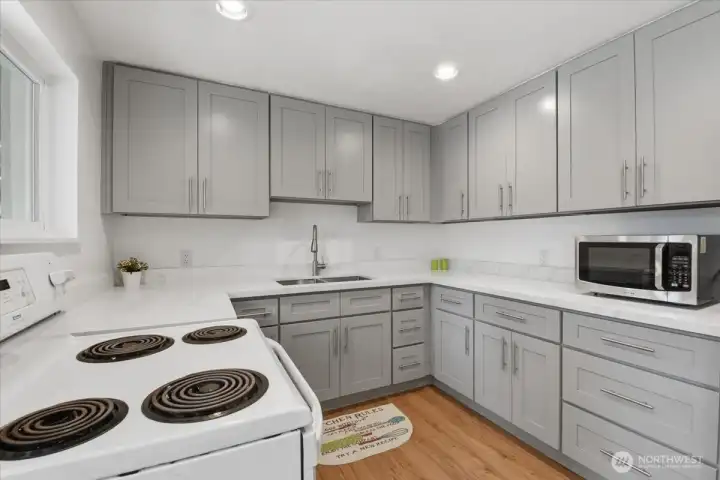 The kitchen was remodeled in 2023 and now boasts plenty of cabinets, a beautiful quartz countertop, new sink/faucet, dishwasher, and recessed can lighting.