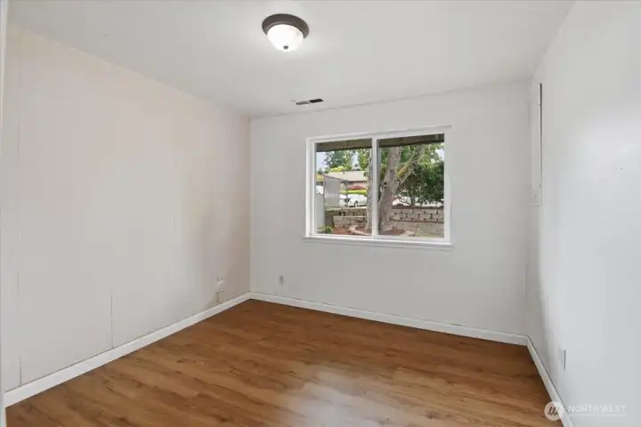 Northeast bedroom with east-facing window looking onto the front yard.
