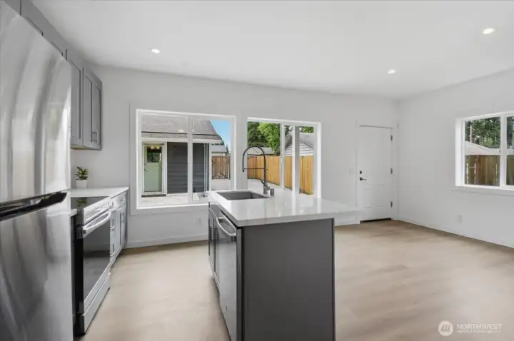 Sunshine cascades into the living room, kitchen and eating space of the DADU courtesy of several large, well positioned windows that face east (front door) and south.