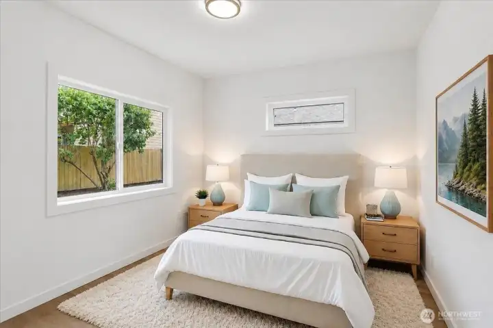 The primary bedroom in the DADU looks out onto the peaceful, private backyard. Gently awaken to fresh air and sunshine provided by north and east-facing windows.  2 windows