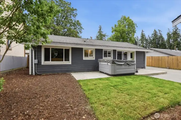 There is a hot tub and patio to enjoy in the private, fully fenced backyard.