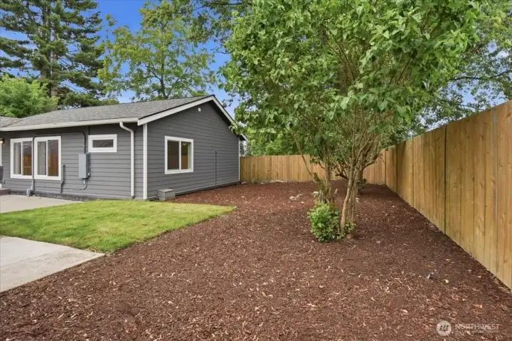 There is plenty of space to create a garden with established lilacs providing a lovely fragrance, shade and additional privacy.