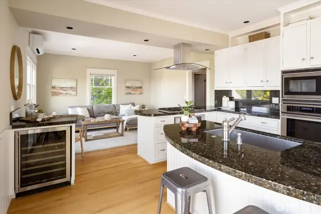 Kitchen w/ wine fridge looking into family room