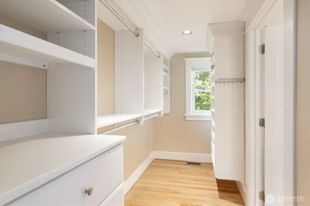 Primary walk in closet with California Closet built-ins