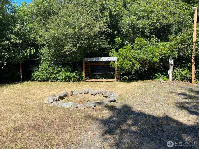 Fire pit and fire wood lean to, power to the right