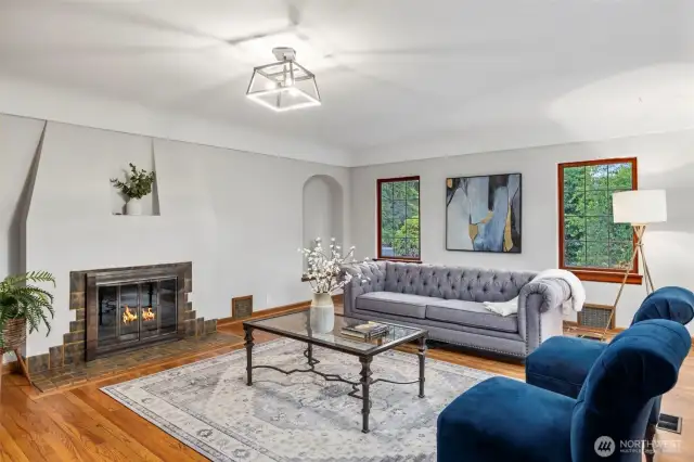 Open and bright living area with wood burning fireplace