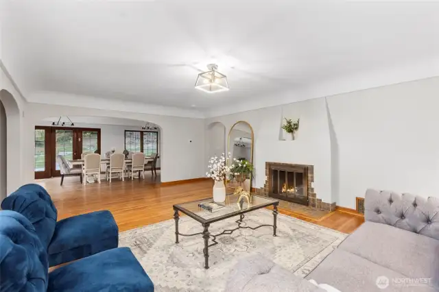 Open and bright living area with wood burning fireplace