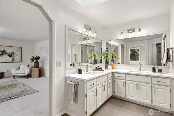 Sleek quartz counters and refreshed cabinets complete this gorgeous bathroom