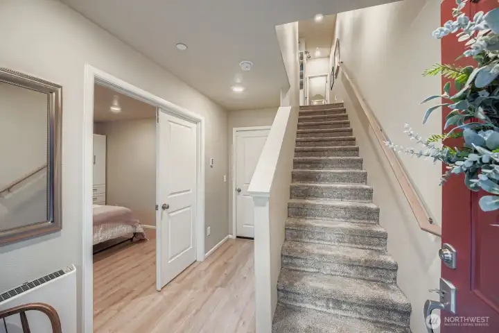 Upon entrance fine access to lower bonus/bedroom, garage and stairwell to upper levels.