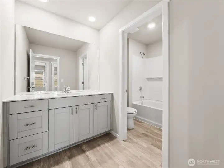 Main hall bath offers separate room for shower/bathtub and toilet.  Finishes and options will vary.