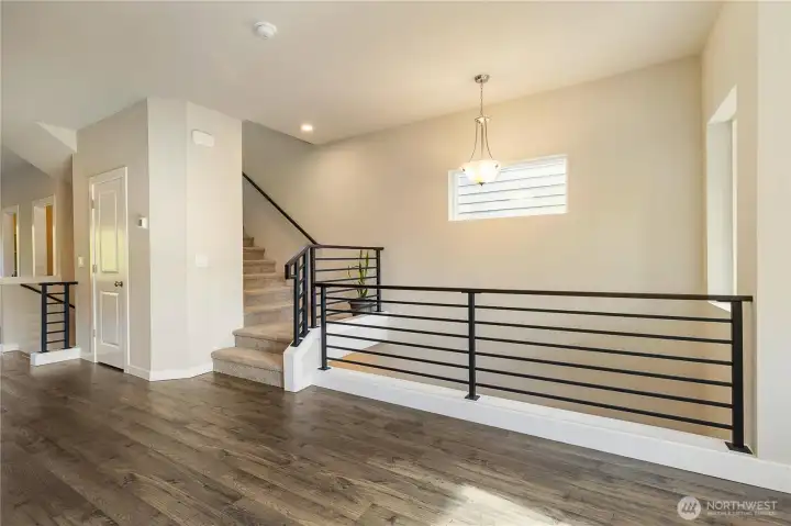 Open second-floor landing with stairs leading to the third floor.