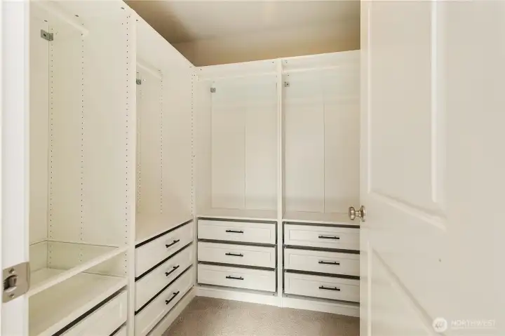Spacious custom walk-in closet in the primary bedroom